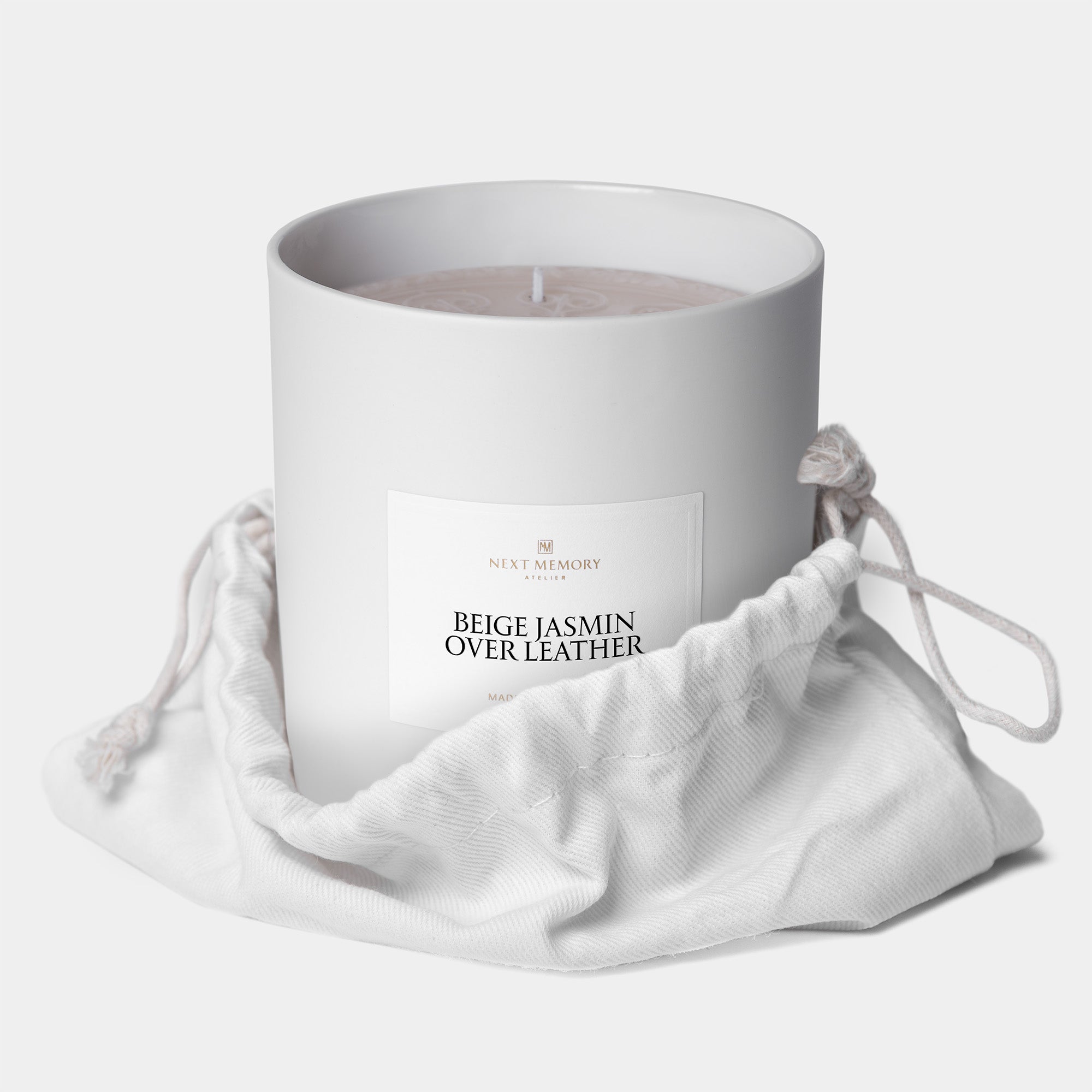 beige jasmin over leather grand medallion candle in a bag