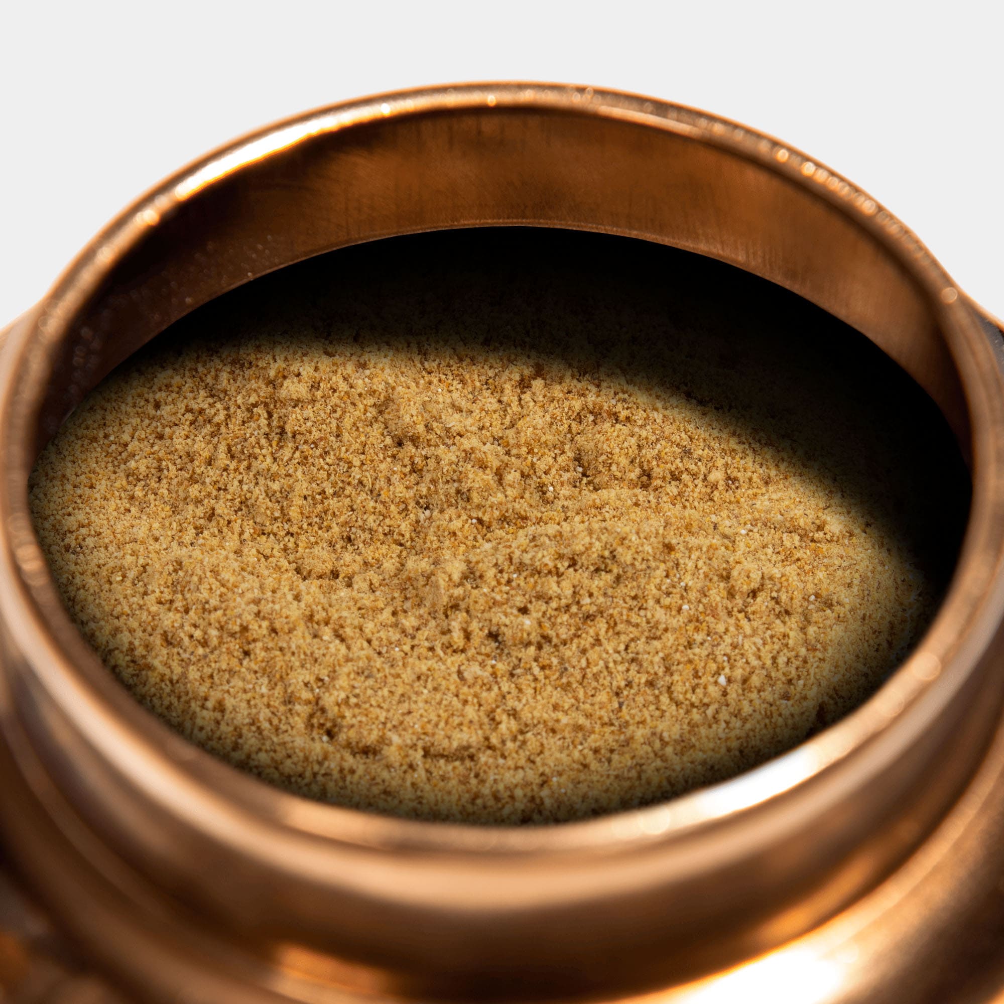 a infusão de boticário apimentada dentro da lata dourada