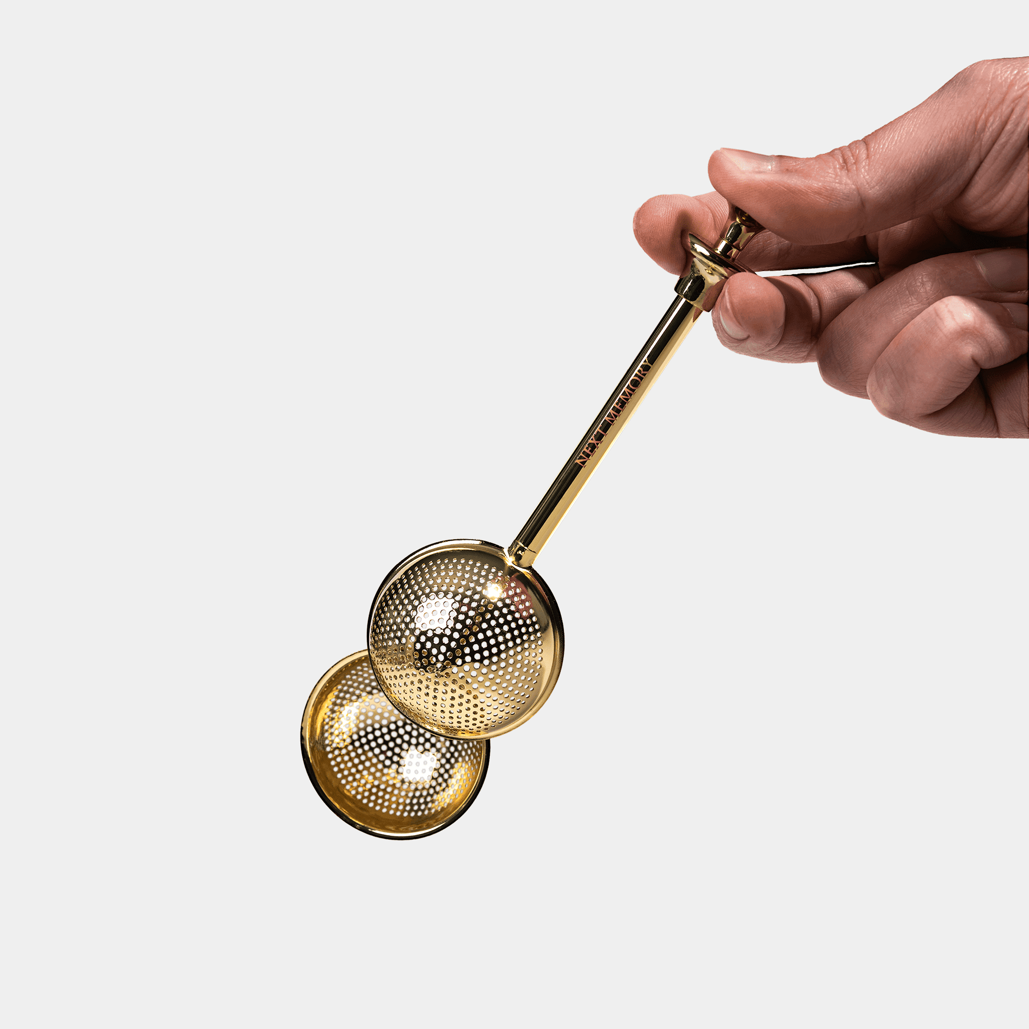 hand holding tea infuser spoon 1980