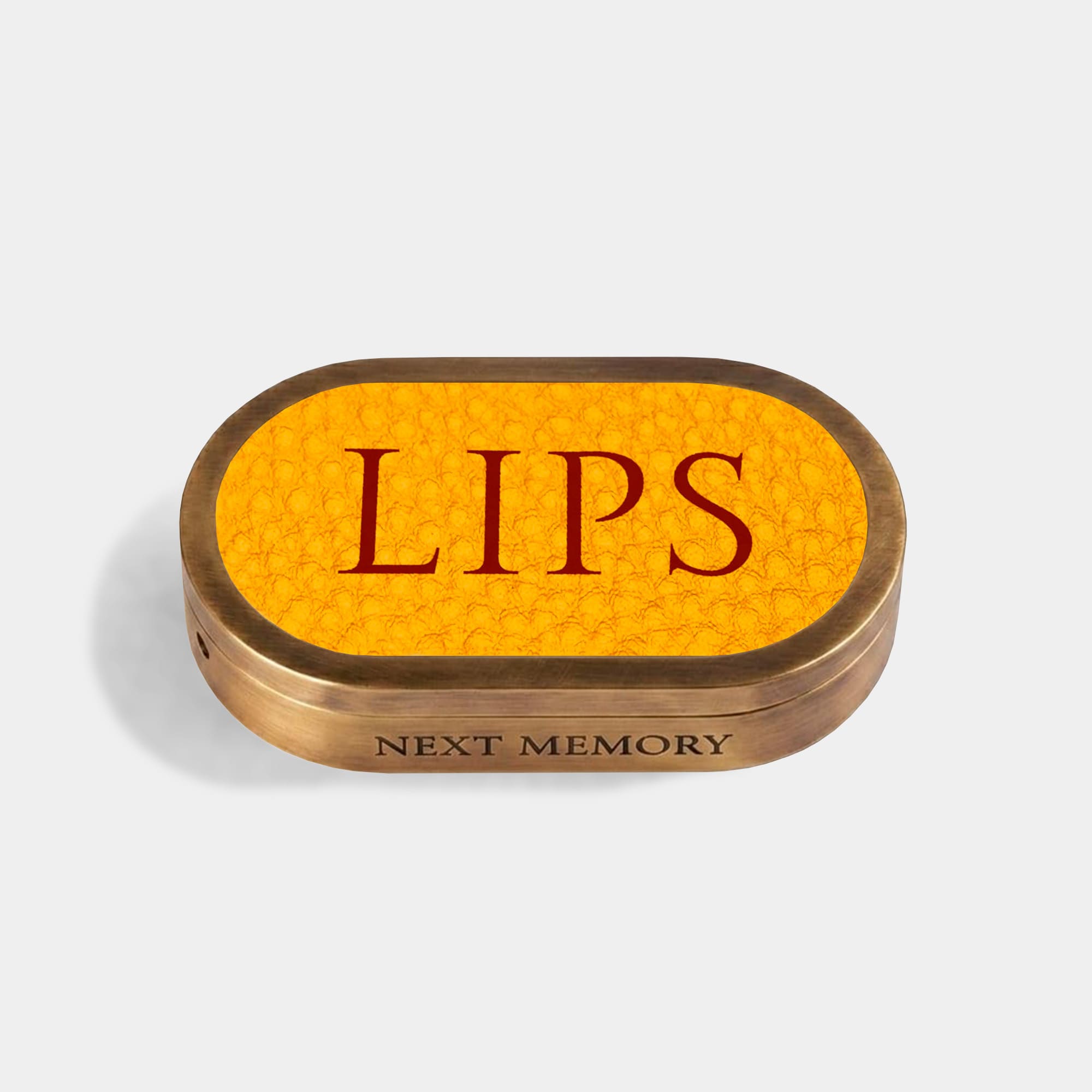 closed pastel de nata lip balm in an aged brass case