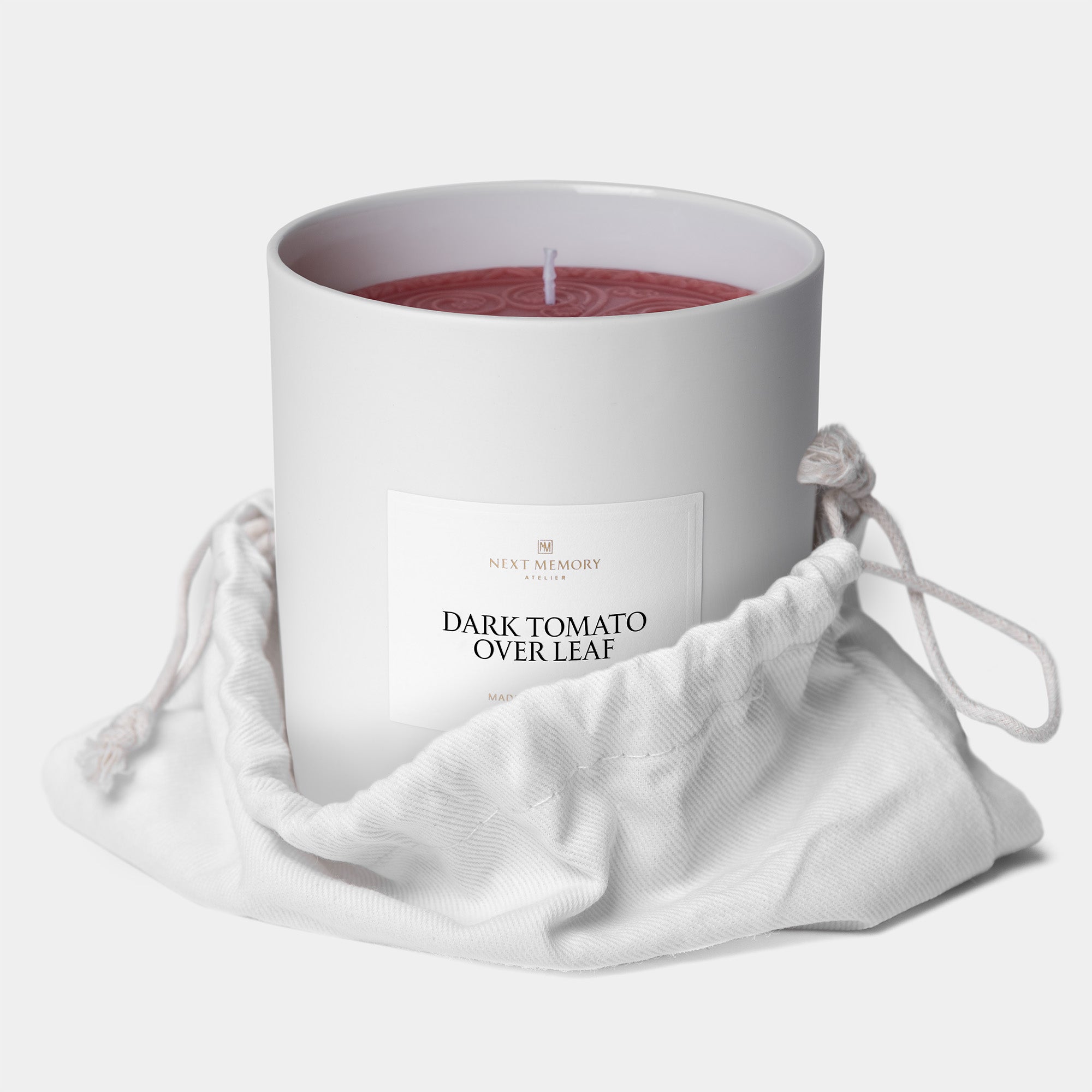 dark tomato over leaf grand medallion candle in a bag
